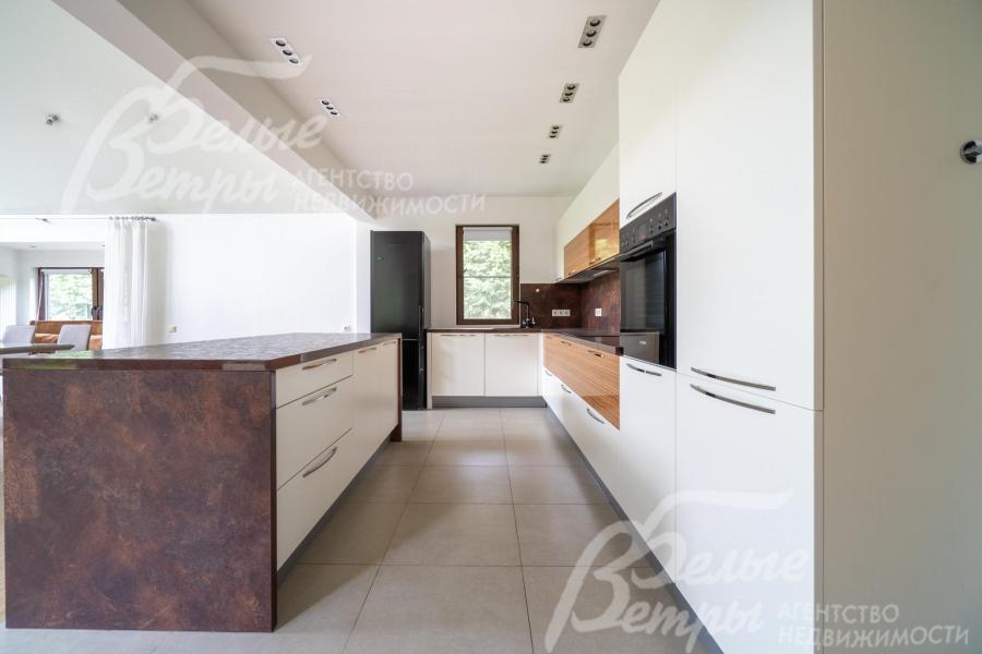 На кухне - гарнитур с полубарным островом и вся необходимая встроенная техника