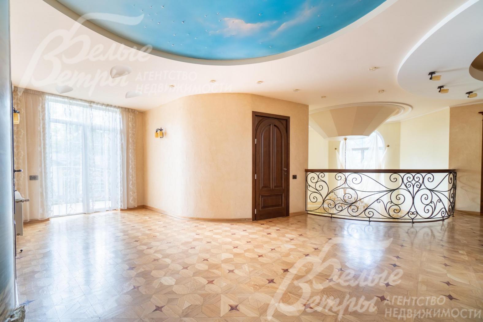 Просторный светлый холл второго этажа с выходом на балкон