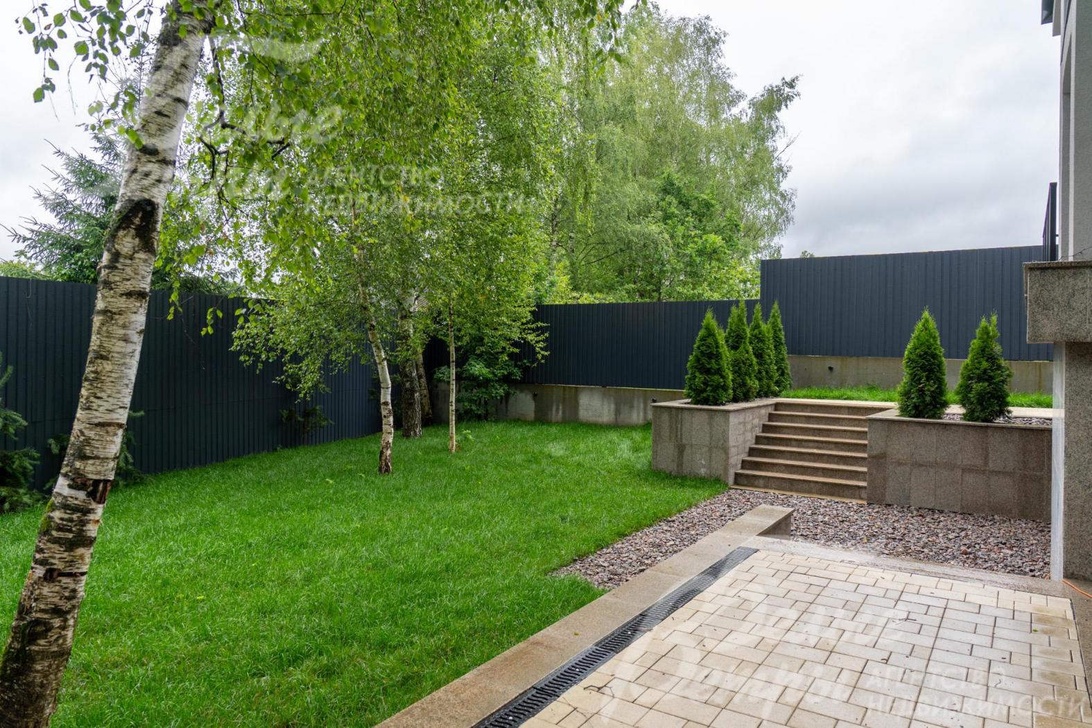 Участок огорожен забором из металлопрофиля высотой 3 м