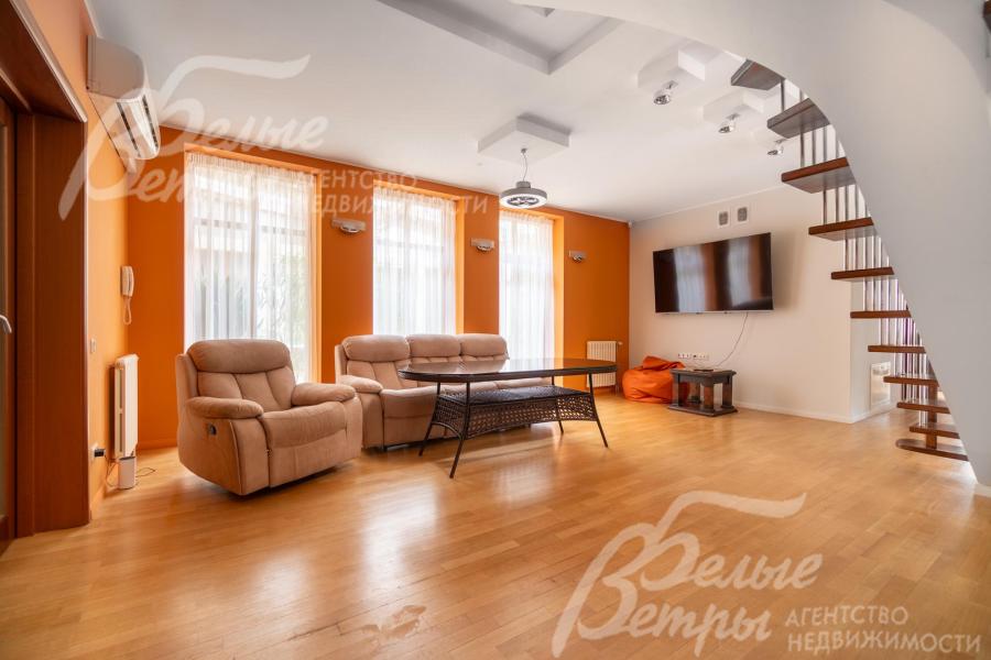 В правом крыле дома находится гостиная-кухня-столовая с диванной группой и телевизором